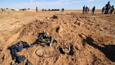 Bits of clothing are seen after they were unearthed from a mass grave of Kurds in west of the city of Samawa, Iraq. (Reuters)