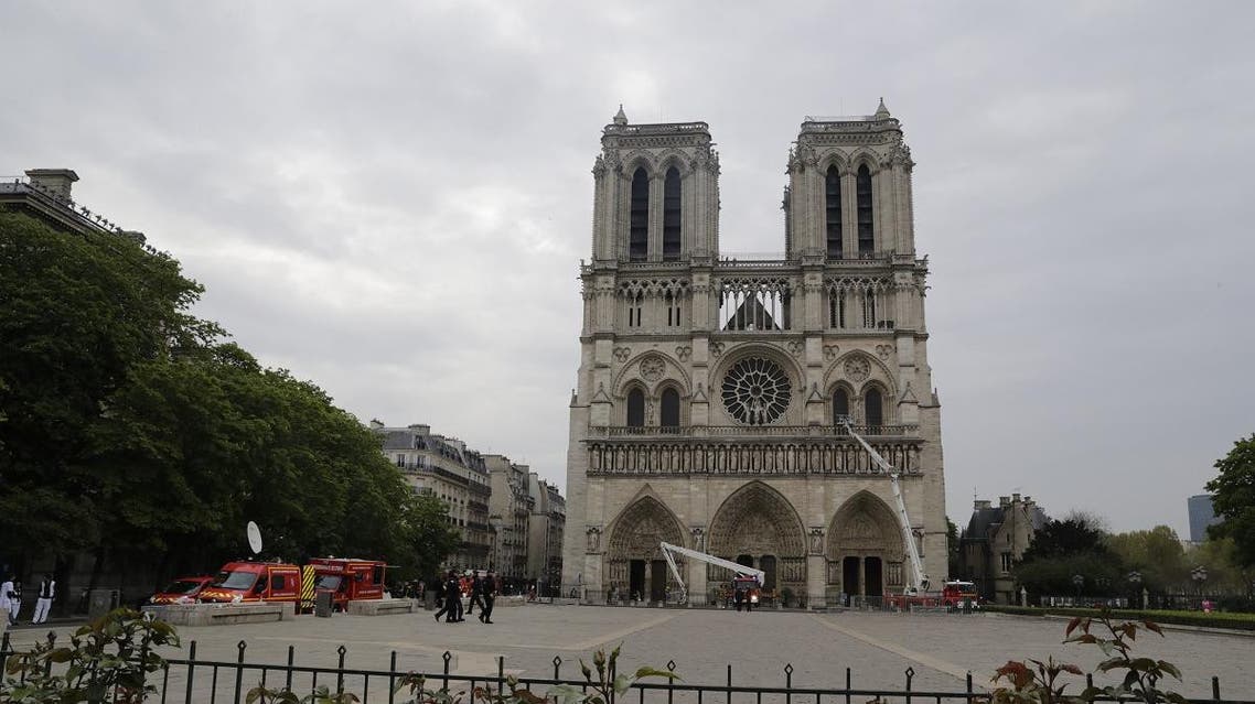 Firefighters secure Notre-Dame Cathedral in Paris on April 16, 2019, in the aftermath of a fire that caused its spire to crash to the ground. (AFP)