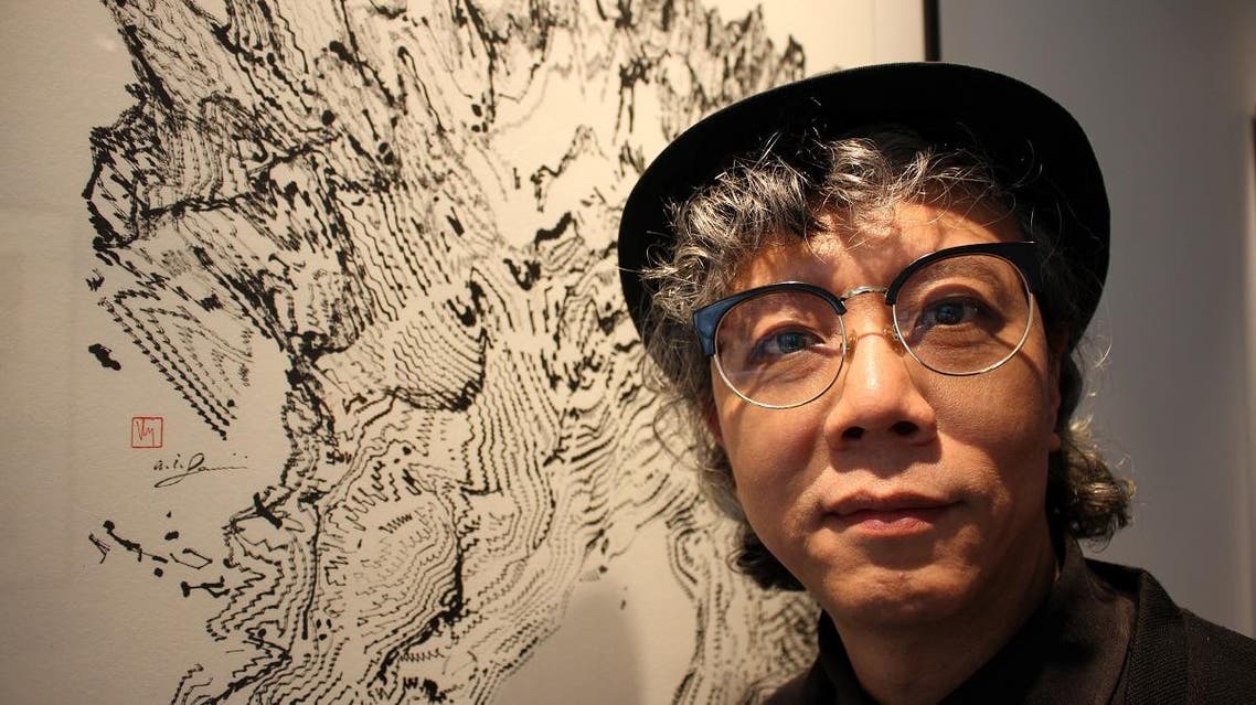 Hong Kong artist Victor Wong stands during his exhibition ‘Far Side of the Moon’ at 3812 Gallery in London, Britain April 16, 2019. (Reuters)