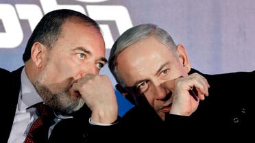 In this Wednesday, Jan. 16, 2013 file photo, Prime Minister Benjamin Netanyahu, right, and former Foreign Minister Avigdor Lieberman speak during a Likud-Yisrael Beitenu campaign rally in the port city of Ashdod. (AP)