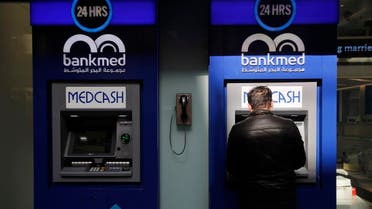 A man uses an ATM outside a bank, in Beirut, Lebanon, Tuesday, Jan. 22, 2019. (AP)