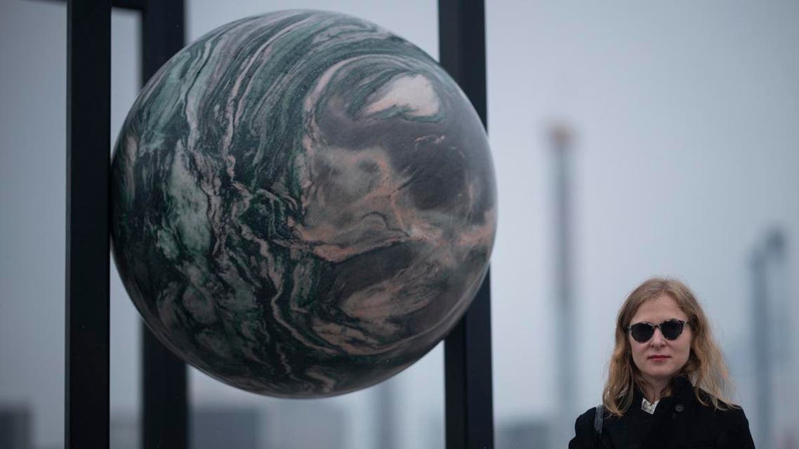 Berlin-based artist Alicja Kwade poses in her sculpture ParaPivot atop the Metropolitan Museum of Art. (AFP)