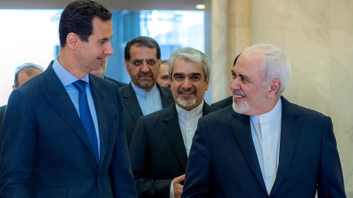 President Bashar al-Assad (L) walking alongside Iranian Foreign Minister Javad Zarif in Damascus. (AFP)