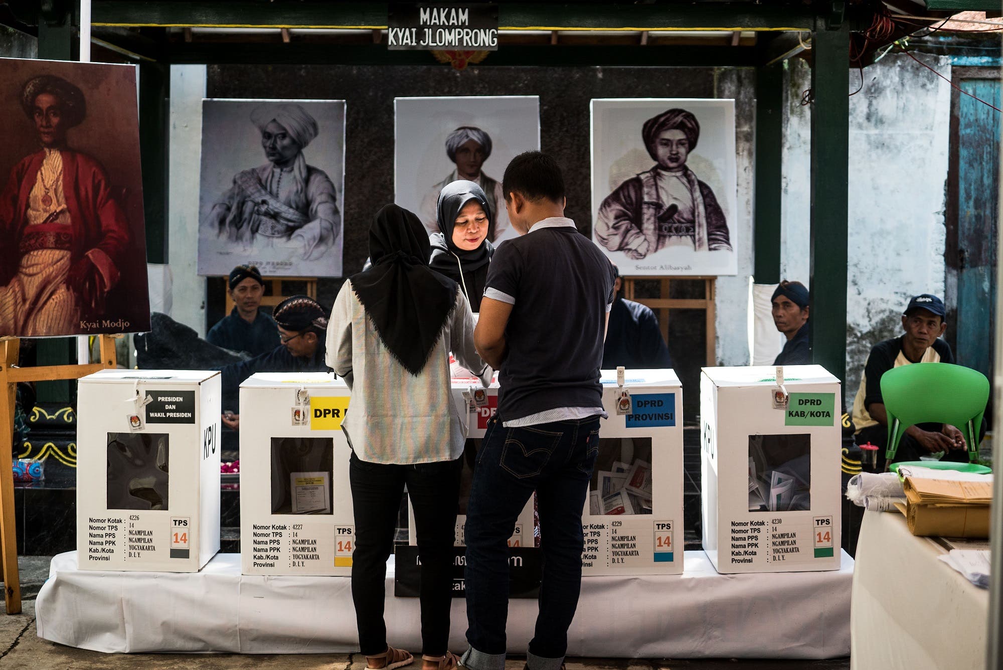 People cast their votes at a polling station during Indonesia's general election in Yogyakarta on April 17, 2019. (AFP)