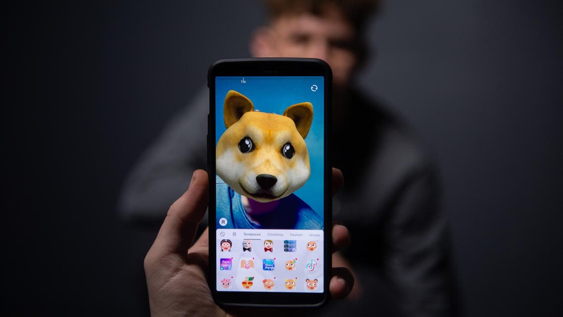 An AFP collaborator poses for a picture using the smart phone application TikTok in Paris on December 14, 2018. (AFP)