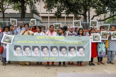 In this photo taken on April 12, 2019 Bangladeshi women hold placards and photographs of schoolgirl Nusrat Jahan Rafi at a protest in Dhaka, following her murder by being set on fire after she had reported a sexual assault. (AFP)
