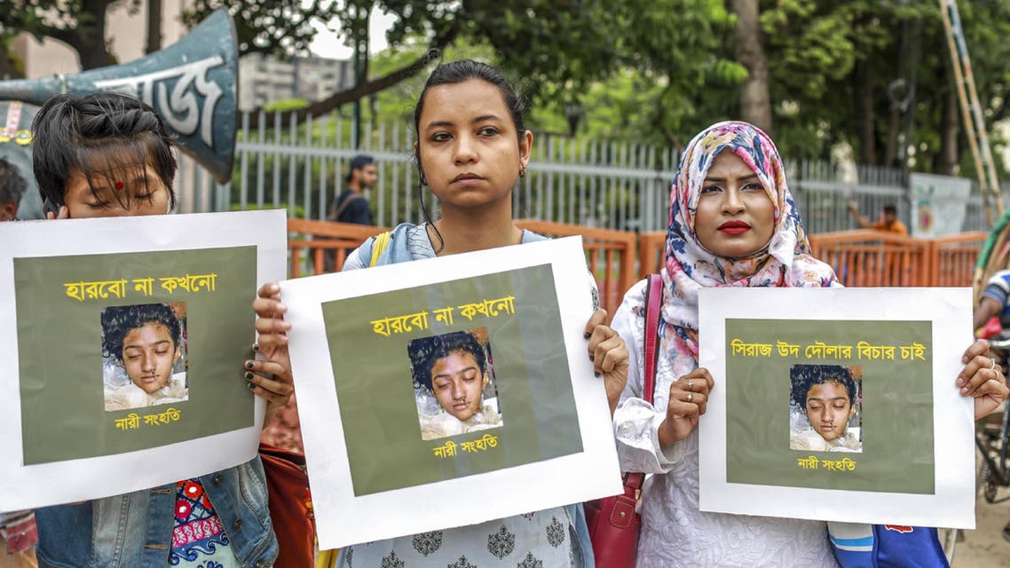 n this photo taken on April 12, 2019 Bangladeshi women hold placards and photographs of schoolgirl Nusrat Jahan Rafi at a protest in Dhaka, following her murder by being set on fire after she had reported a sexual assault. (AFP)