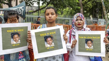 n this photo taken on April 12, 2019 Bangladeshi women hold placards and photographs of schoolgirl Nusrat Jahan Rafi at a protest in Dhaka, following her murder by being set on fire after she had reported a sexual assault.  (AFP)