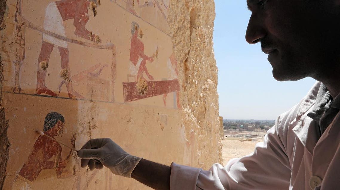 An Egyptian archaeologist works inside one of the largest newly discovered pharaonic tombs "Shedsu Djehuty" in Luxor, Egypt, on April 18, 2019. (Reuters)