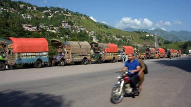 Trucks loaded with Indian goods are left parked on a road side after relatives of Pakistani Kashmiri truck drivers detained in Indian-held Kashmir on alleged drugs smuggling charges blocked the vehicles on the outskirts of Muzaffarabad, in Pakistani-administered Kashmir, on August 20, 2017. (AFP)