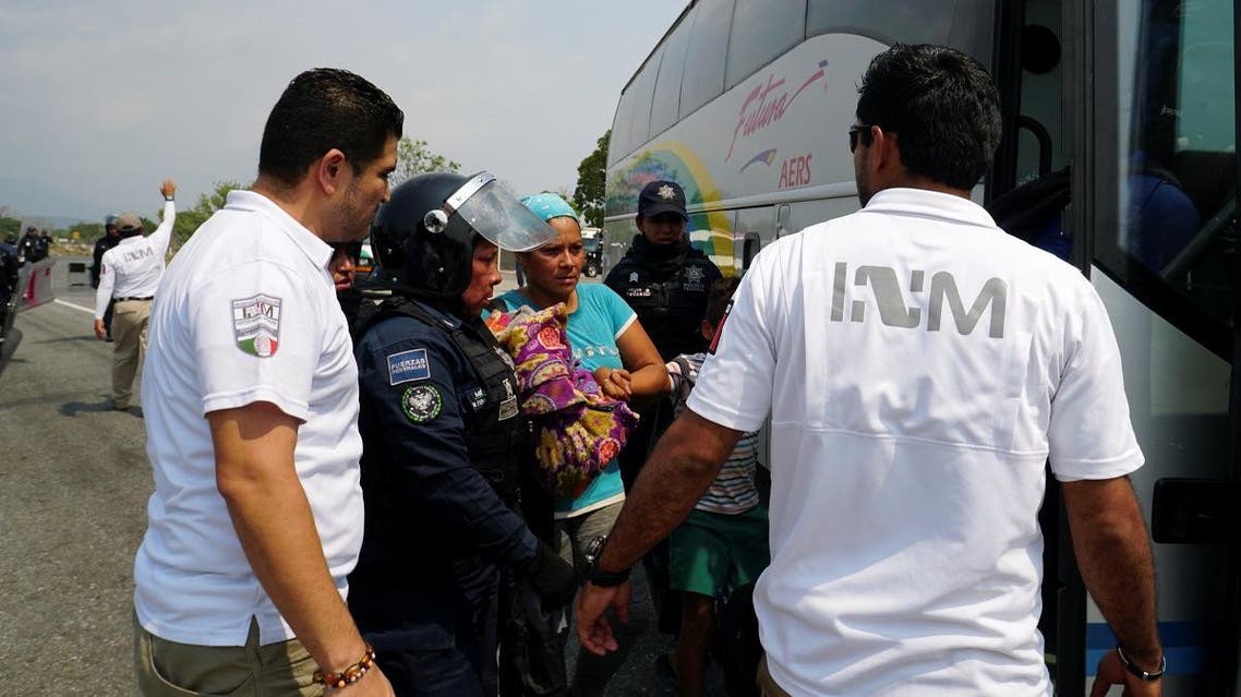 A Central American migrant is detained by a Federal Police officer on an immigration raid during their journey towards the United States, in Mapastepec, Mexico, on April 19, 2019. (Reuters)