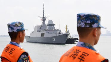 This photo taken on October 21, 2018 shows Chinese sailors watching as a navy ship arrives at a military port in Zhanjiang, in China's southern Guangdong province (AFP)