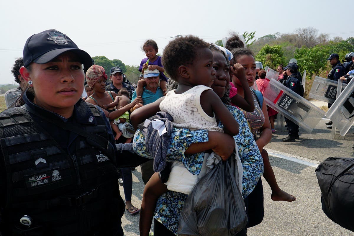 A Central American migrant is detained by a Federal Police officer in Mapastepec, Mexico. (Reuters)