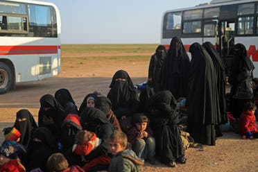 Women and children evacuated from ISISI last holdout of Baghouz wait to undergo security screening by US-backed Syrian Democratic Forces (SDF) fighters (not pictured) in Syria’s northern Deir Ezzor province, on February 22, 2019. (AFP)