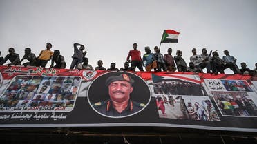 Sudanese protestors shout slogans as they wave Sudan national flags during a protest outside the army complex in the capital Khartoum on April 20, 2019. (AFP)