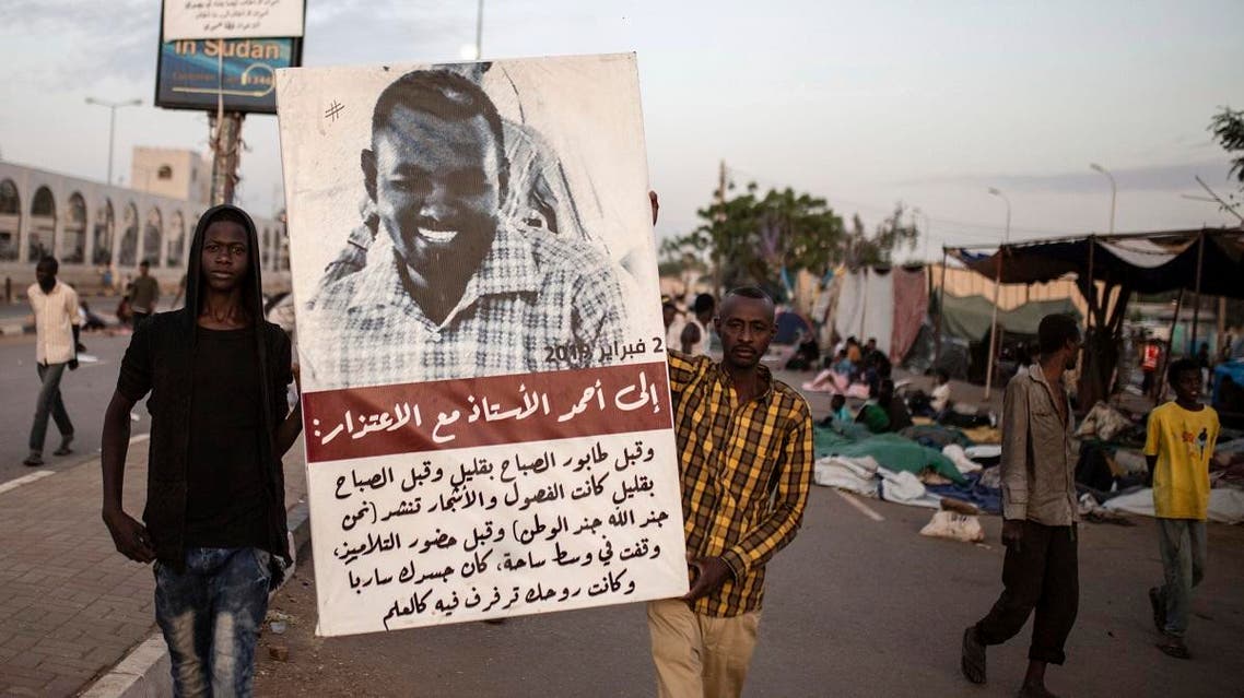 Protesters carry posters featuring photos of the martyrs as thousands marched toward the main sit-in outside the military headquarters in Khartoum, Sudan. (AP)