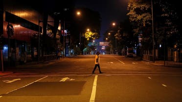 A man crosses a road during the curfew after multiple explosions in the country, in Colombo. (Reuters)