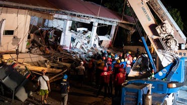 Rescue workers search for survivors in a collapsed Chuzon Super Market in Porac, Pampanga, after a powerful earthquake hit northern Philippines. afp