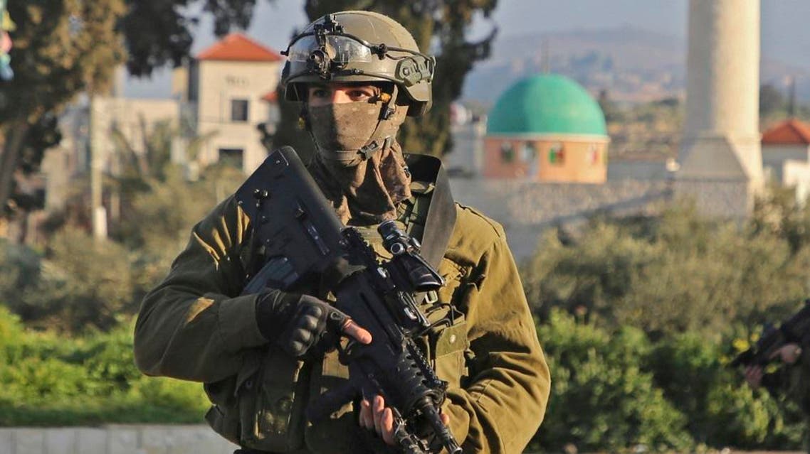 An Israeli soldier stands guard in a street in the northern West Bank village of Salem, east of Nablus, on March 18, 2019. (AFP)