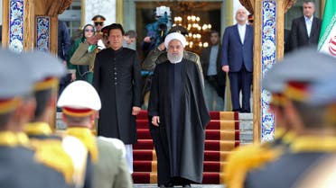 Iranian President Hassan Rouhani (R) and Pakistani Prime Minister Imran Khan, standing to the national anthem in the Iranian capital Tehran. (AFP)