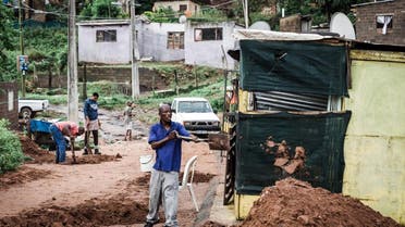 People begin to clear debris at an informal settlement of BottleBrush, south of Durban, after torrential rains and flash floods caused huge damages to their homes on April 23, 2019. The death toll from floods and mudslides that crushed homes in the South African port of Durban on April 23 has risen to 33, with reports of children missing and scores of people displaced, authorities said. RAJESH JANTILAL / AFP