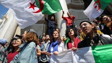Demonstrators hold flag during anti government protests in Algiers. (Reuters)