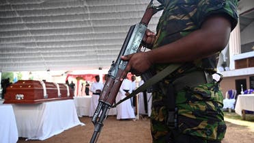 A soldier stands guard near a coffin of a bomb blast victim during a funeral service at St Sebastian’s Church in Negombo on April 23, 2019. (AFP)
