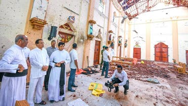 This handout photo taken and released by the Sri Lankan President's Office on April 23, 2019 shows President Maithripala Sirisena (2nd L) visiting St. Sebastian's church in Negombo, two days after a series of bomb attacks targeting churches and luxury hotels in Sri Lanka. Sri Lanka began a day of national mourning April 23 with three minutes of silence to honour more than 300 people killed in suicide bomb blasts that have been blamed on ISIS