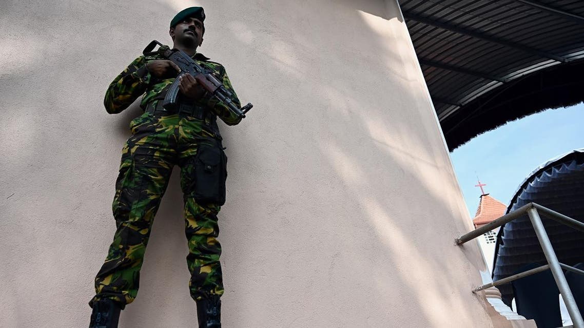 A soldier stands guard during a memorial service for bomb blast victims at St Sebastian’s Church in Negombo on April 23, 2019. (AFP)