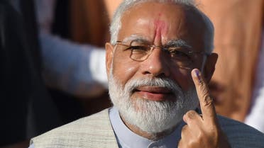 Indian Prime Minister Narendra Modi displays his ink-marked finger after casting his vote during the third phase of general elections at a polling station in Ahmedabad on April 23, 2019. (AFP)
