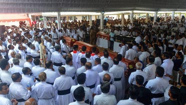 Sri Lankan priests and relatives bless the coffins of bomb blast victims after a funeral service at St. Sebastian's Church in Negombo on April 23, 2019. (AFP)