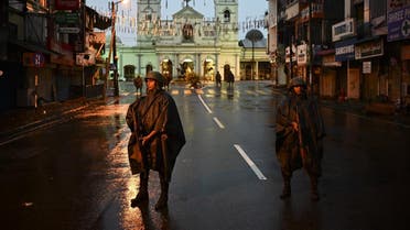 Sri Lankan soldiers stand guard under the rain at St. Anthony's Shrine in Colombo on April 25, 2019. (AFP)