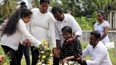 Family members mourn for their mother, a victim of the suicide attacks on churches and luxury hotels, at the site of a mass burial in Negombo, Sri Lanka, on April 25, 2019. (Reuters)
