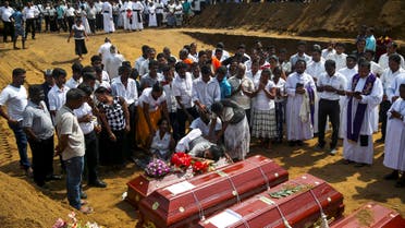People react during a mass burial of victims, two days after a string of suicide bomb attacks on churches and luxury hotels across the island on Easter Sunday, at a cemetery near St. Sebastian Church in Negombo, Sri Lanka April 23, 2019. (Reuters)