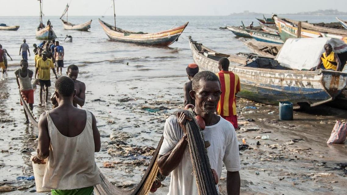 Traditional fishermen carry fish nets to the Goderich Market in Sierra Leone’s capital Freetown on April 10, 2019. (AFP)