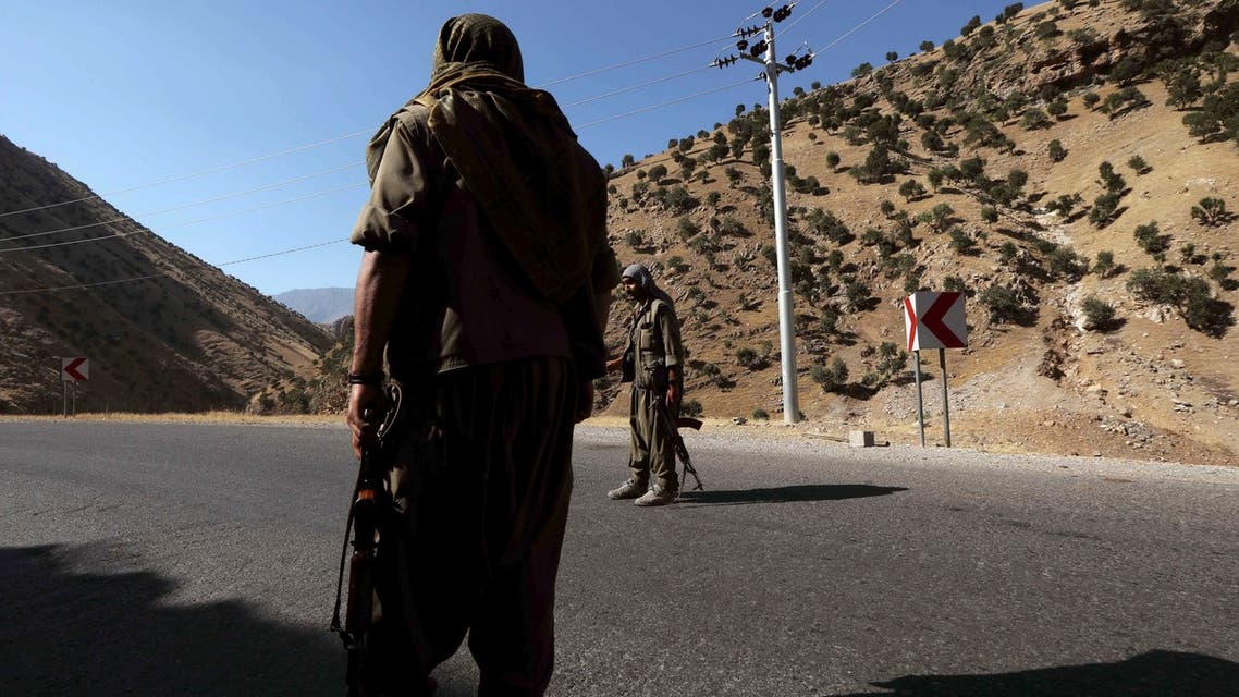 A member of the Kurdistan Workers' Party (PKK) carries an automatic rifle on a road in the Qandil Mountains, the PKK headquarters in northern Iraq, on June 22, 2018. Hundreds of Iraqi Kurds marched Friday to protest Turkish strikes against the Kurdistan Workers' Party (PKK) after Turkey's President Recep Tayyip Erdogan said Ankara would press an operation against its bases.