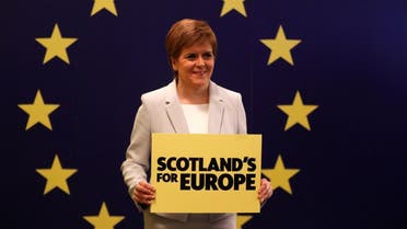 Scotland's First Minister Nicola Sturgeon stands in front of a European Union flag at the Scottish National Party (SNP) conference in Edinburgh. (Reuters)