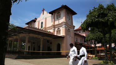 Sri Lankan Roman Catholic priests walk past damaged St. Sebastian's Church in Katuwapitiya village in Negombo, north of Colombo, Sri Lanka (AP)