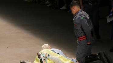Model Tales Soares is taken from the catwalk by paramedics after he collapsed during Sao Paulo Fashion Week in Sao Paulo, Brazil, Saturday, April 27, 2019. (AP)