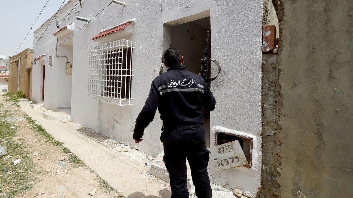 File photo of a Tunisian security officer outside a house where two suspected extremists were killed during a security operation in the country. (AFP)
