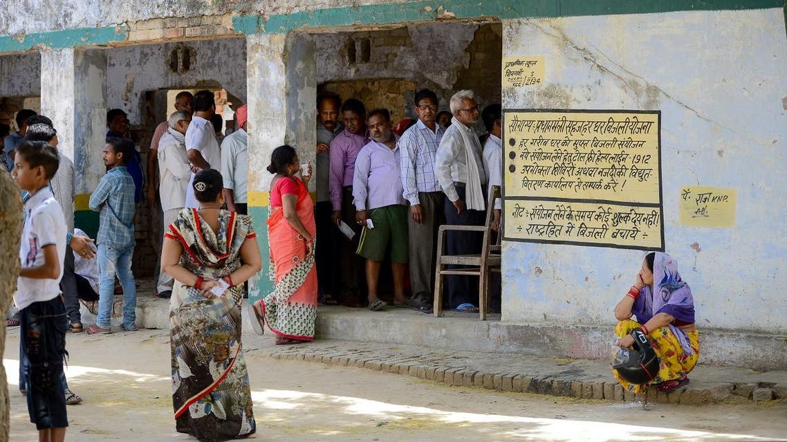 Indian voters stand in a queue to cast their vote at a polling station, in Kanpur. (AFP)