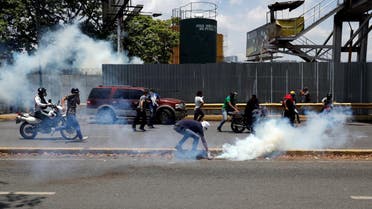 Opposition demonstrators clash with security forces near the Generalisimo Francisco de Miranda Airbase "La Carlota" in Caracas, Venezuela. (Reuters)