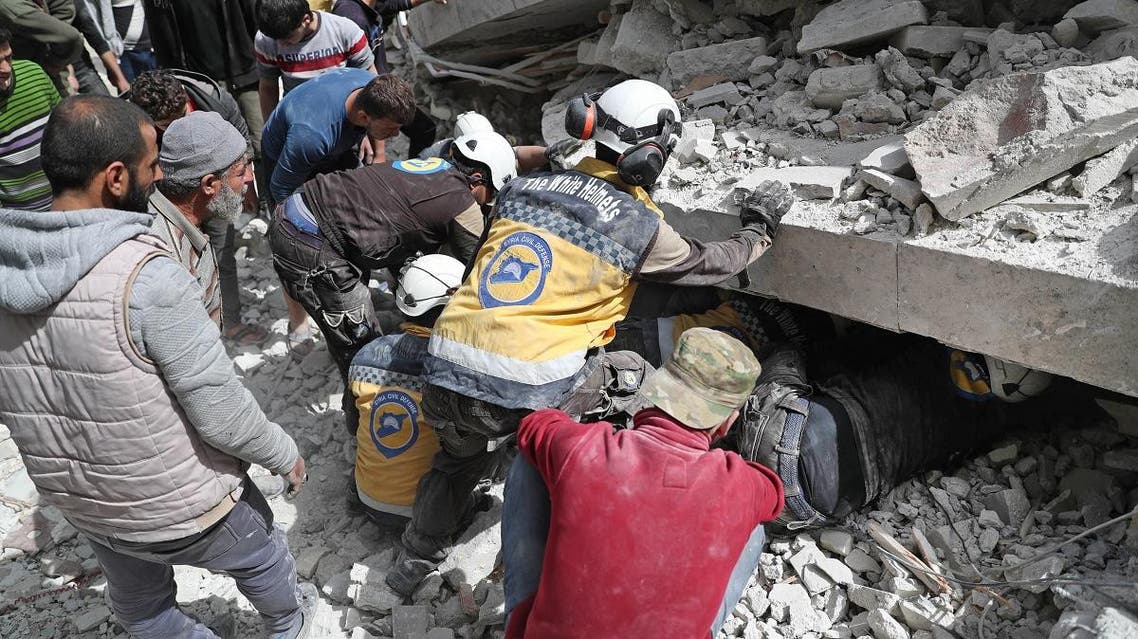 Members of the Syrian Civil Defence search the rubble of a collapsed building following an explosion in the town of Jisr al-Shughur, in the west of the mostly rebel-held Syrian province of Idlib. (AFP)