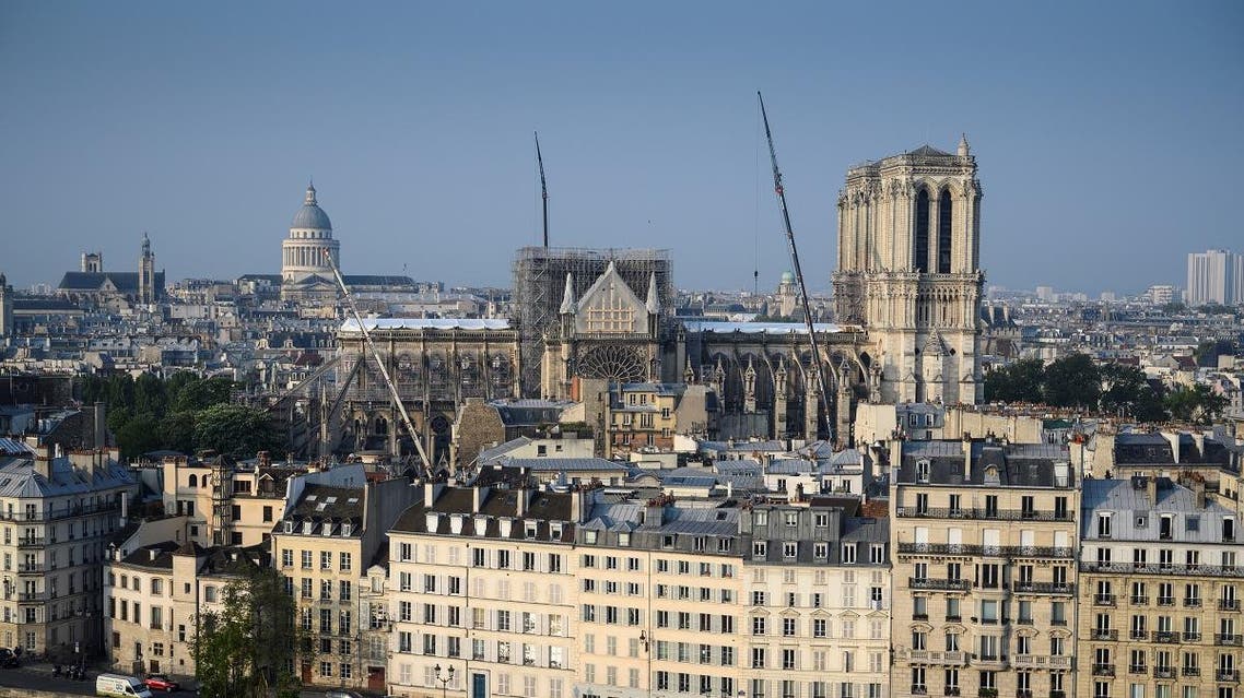 An aerial view taken from the Hotel de Ville or City Hall shows the Notre-Dame de Paris Cathedral located on the Ile de la Cité, with the Panthéon (L) in Paris on April 30, 2019. Paris was struck in its very heart as flames devoured the roof of Notre-Dame, on April 15, 2019, the medieval cathedral made famous by Victor Hugo, its two massive towers flanked with gargoyles instantly recognisable even by people who have never visited the city. Eric Feferberg / AFP