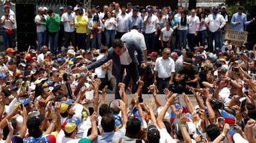 Venezuelan opposition leader Juan Guaido takes part in a swearing-in ceremony for supporters in Caracas. (Reuters)