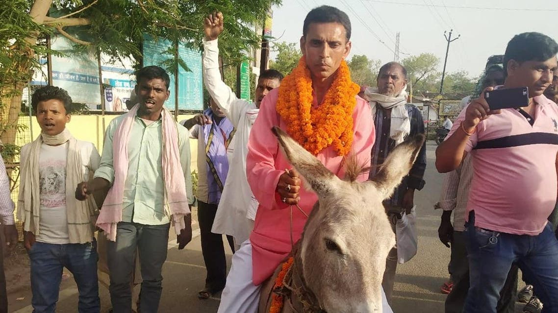 Mani Bhushan Sharma arrives on a donkey to file his nomination documents at an election office in Jehanabad, Bihar. (AFP)