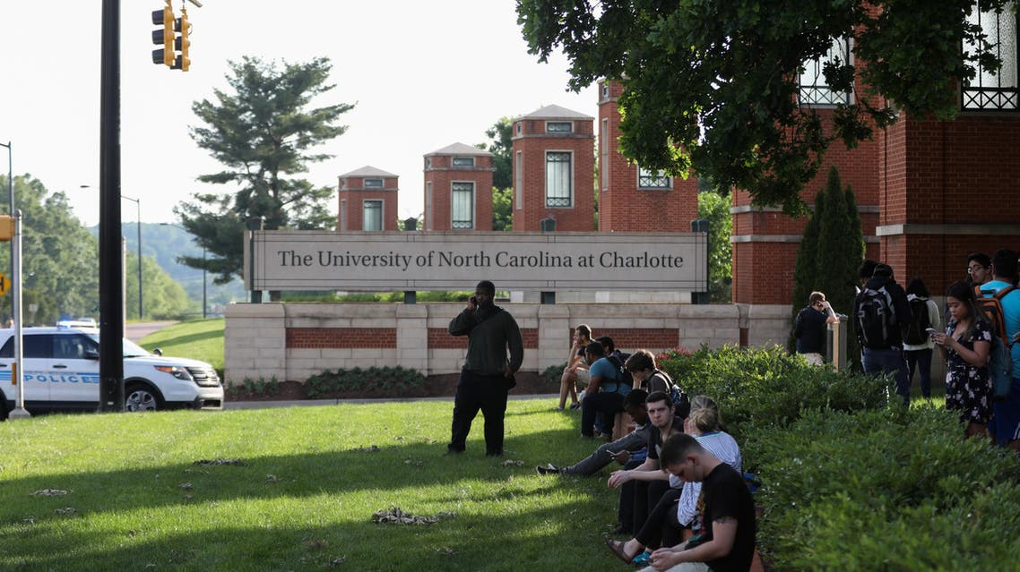 Students and faculty wait near the entrance of campus after a shooting on the campus of University of North Carolina Charlotte in University City, Charlotte, on April 30, 2019. (AFP)