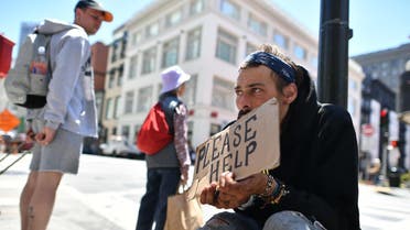 Andrew Loy begs along a sidewalk in downtown San Francisco, California on Tuesday, June, 28, 2016. (AFP)