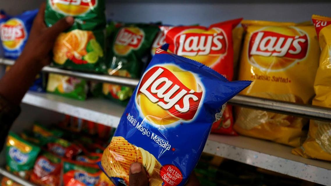A customer picks packets of Lay’s potato chips at a shop in Ahmedabad, India, April 26, 2019. (Reuters)