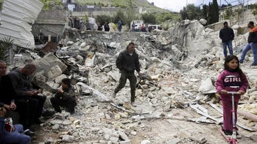 Palestinians watch a family house destroyed by Israeli authorities in east Jerusalem's neighborhood of Silwan. (AP)